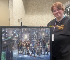 Megan Frye poses with an original painting from Jeff Porter